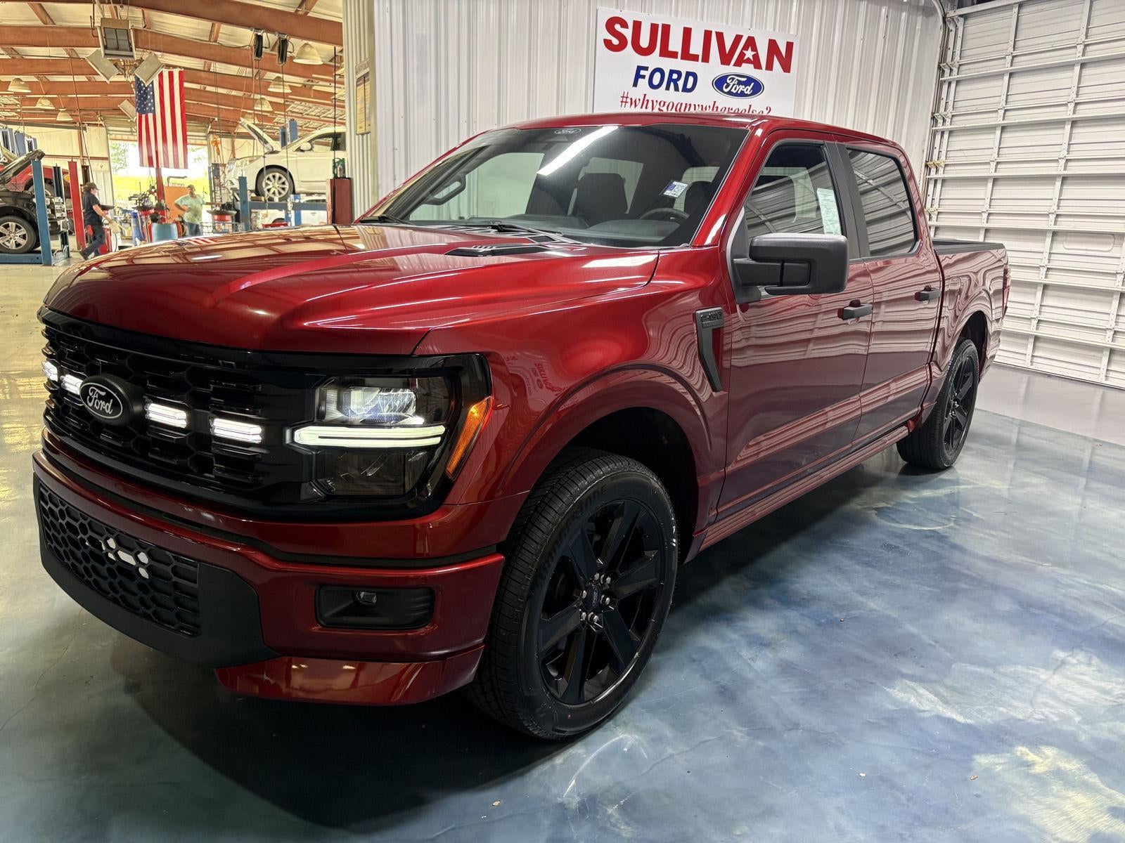 2026 Ford F-150 STX in Ruby Red Metallic Tinted Clearcoat — front three-quarter view