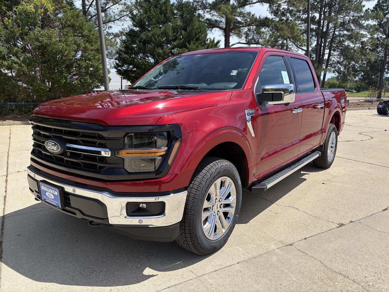 2026 Ford F-150 XLT in Ruby Red Metallic Tinted Clearcoat — front three-quarter view